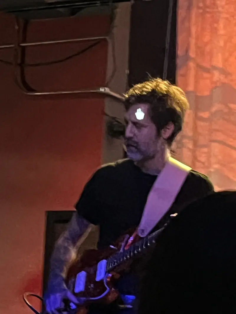 Royal Thunder guitarist with a mouse pointer projected onto his face
