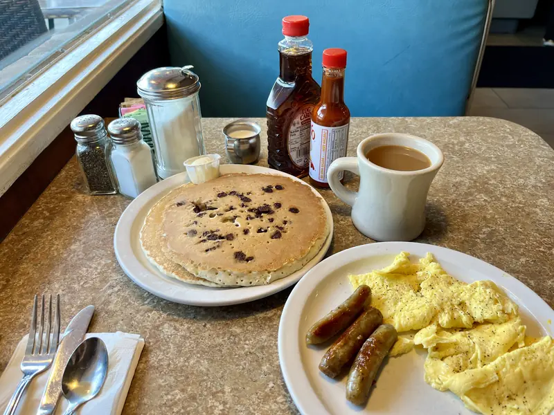 Eggs, coffee, bacon, and chocolate chip pancakes