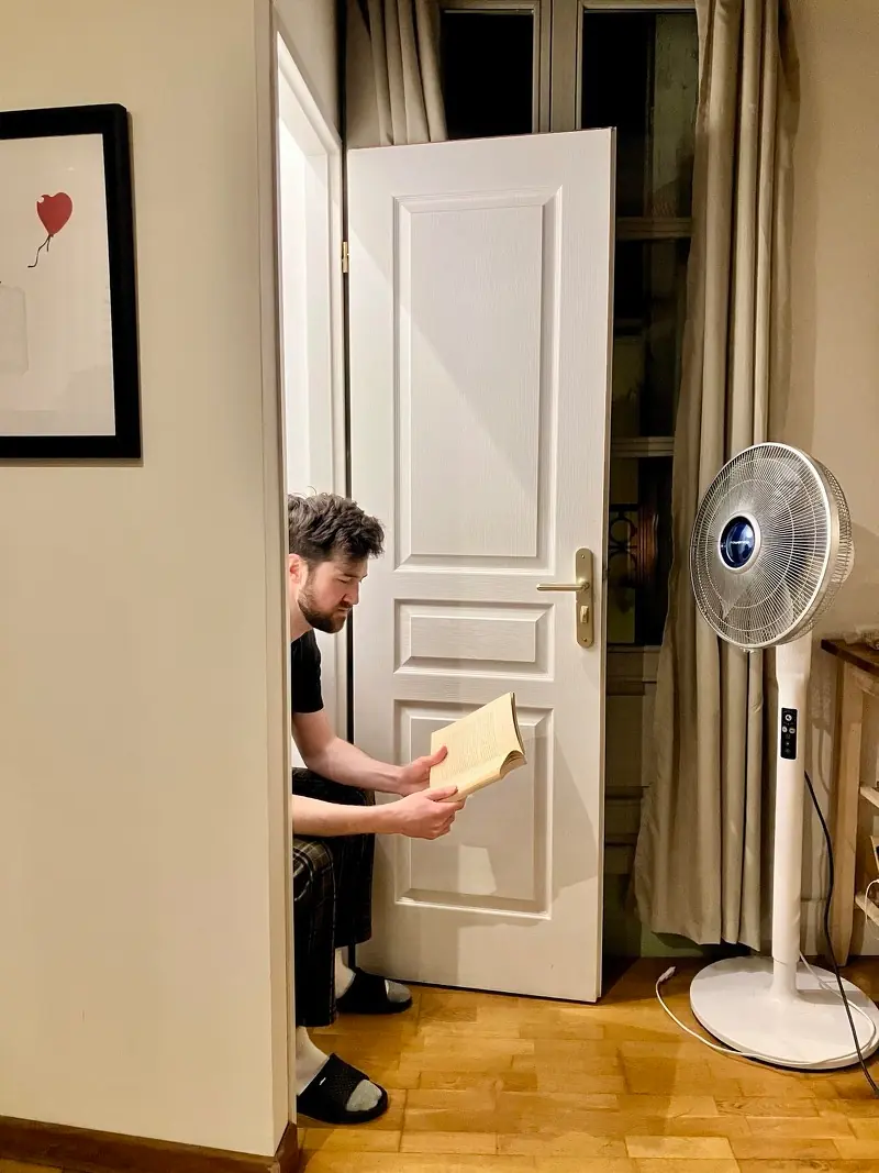 Side view of Nate sitting in a French toilet